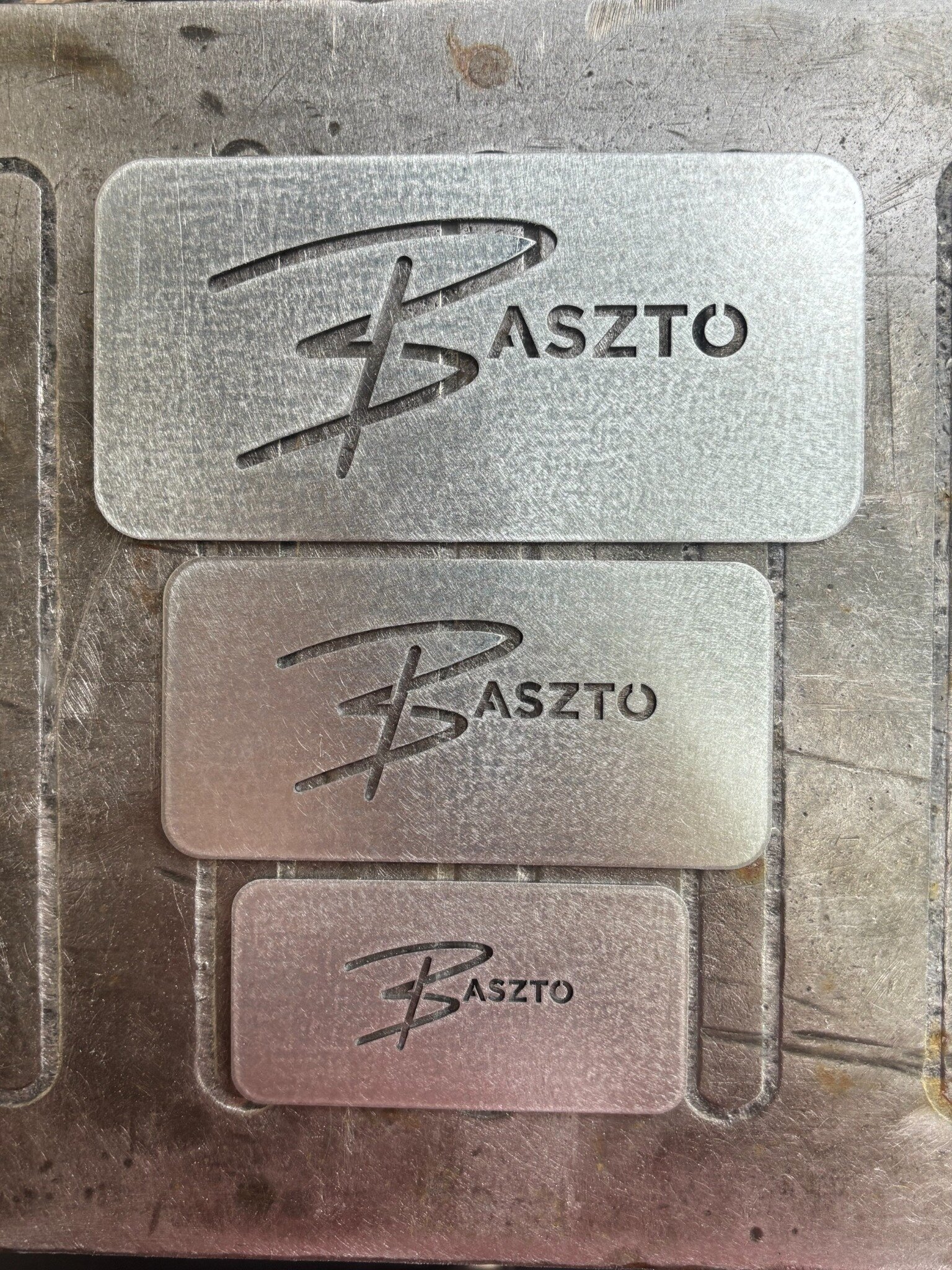 Three sizes of precision-cut Baszto galvanized steel logo stencils