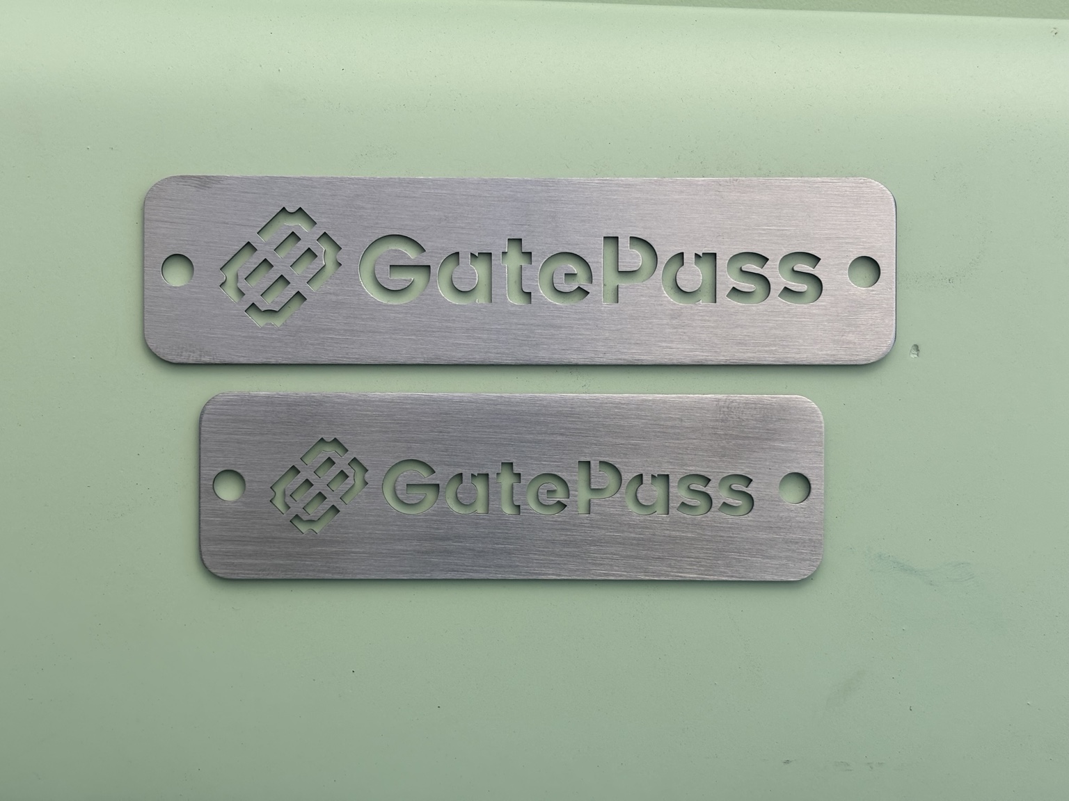 Two precision cut GatePass metal tags